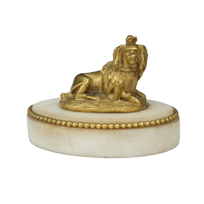 Find an antique desk paperweight of a King Charles spaniel on a marble base.