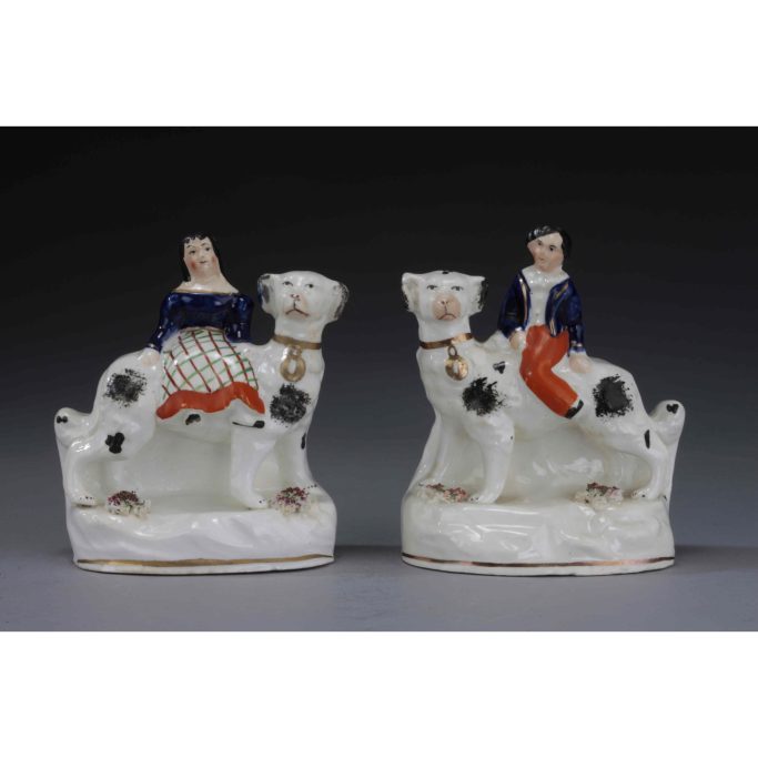 Find antique Staffordshire figures of children riding on dogs backs for sale.