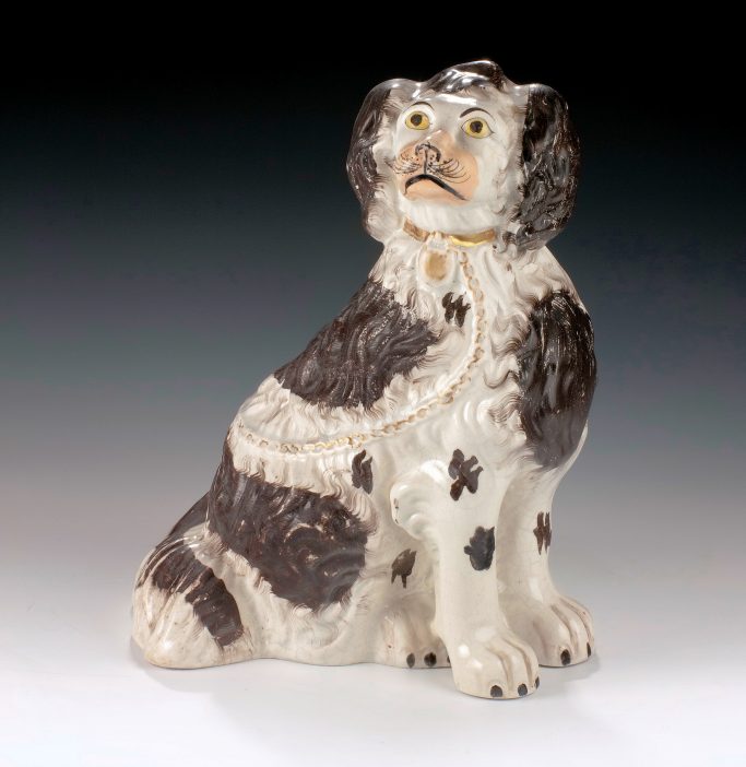 Find an large antique Staffordshire figure of a seated spaniel dog for sale.