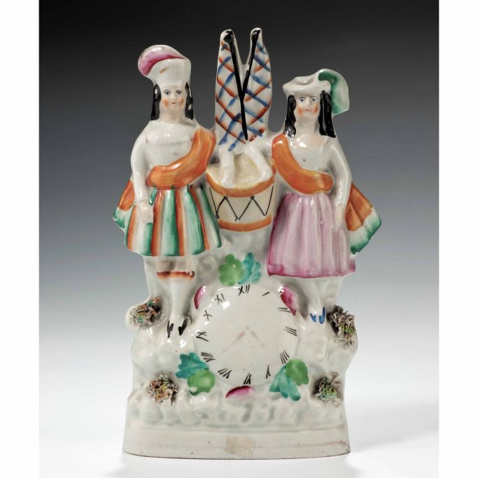 Find an antique Staffordshire figure with children, drum and clock face for sale.